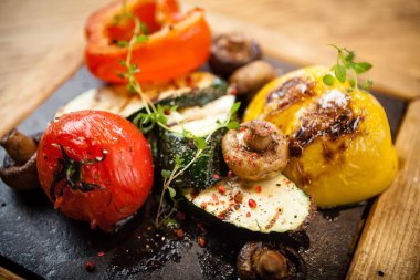 Taş bir tahta üzerinde ızgara sebze