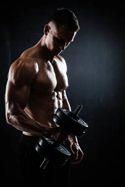 Athletic male with dumbbells — Stock Photo, Image