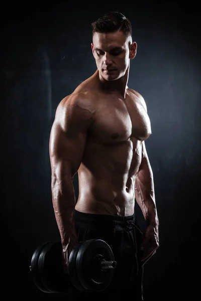 Athletic male with dumbbells — Stock Photo, Image