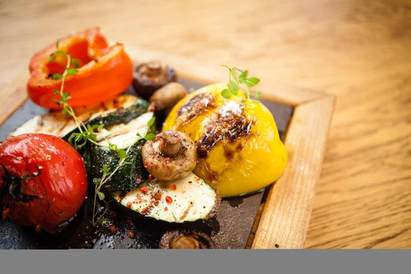 Taş bir tahta üzerinde ızgara sebze