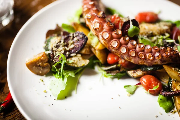 Bläckfisksallad serverad på tallrik i restaurang — Stockfoto