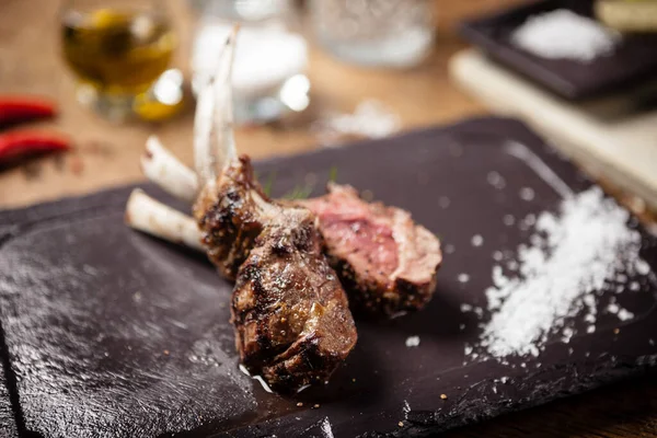 Grilled lamb chops served with a branch of rosemary — Stock Photo, Image