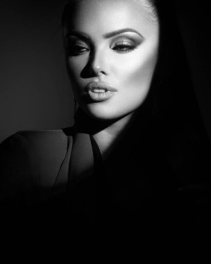 stylish lady in a spot of light in monochrome