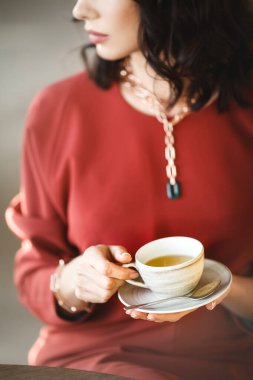 Young business lady with luxury accessories in cafe