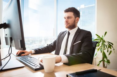 Young businessman in office sitting at his desk