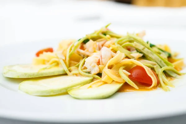 Tagliatelle with tiger prawns served on a plate — 图库照片