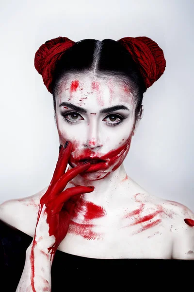 Portrait of a girl in a high fashion, beauty style with red palms facing behalf, white skin, red lips make up at silver background. Vampire makeup Fashion Art design. Halloween holiday concept — Stock Photo, Image