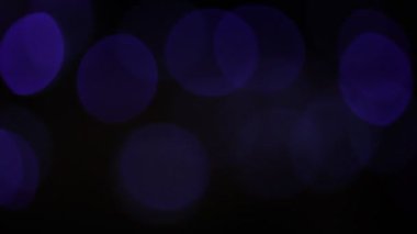 Yuvarlak Bokeh Noel 'i ve mutlu yıllar ışıltılı ışıklar. Siyah arkaplan ile soyut bokeh