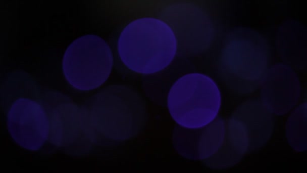 Bokeh circulaire Noël et Bonne année scintille lumières. Bokeh abstrait avec fond noir 