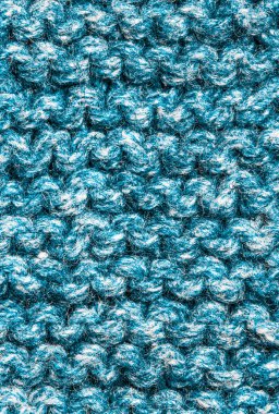 Pürüzsüz bej örgü kumaştan örülmüş, at kuyruklu. Tekrar eden Makine Örgü Süveter Dokusunu. Bej örgülü arka plan. Mavi örgü yün, ağ, örgü. Uzayı kopyala Hobi konsepti