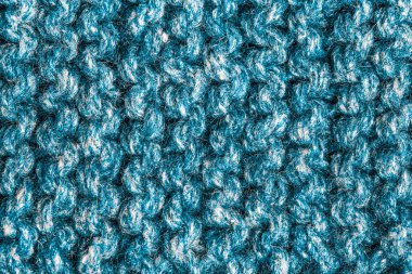 Pürüzsüz bej örgü kumaştan örülmüş, at kuyruklu. Tekrar eden Makine Örgü Süveter Dokusunu. Bej örgülü arka plan. Mavi örgü yün, ağ, örgü. Uzayı kopyala Hobi konsepti