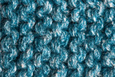 Pürüzsüz bej örgü kumaştan örülmüş, at kuyruklu. Tekrar eden Makine Örgü Süveter Dokusunu. Bej örgülü arka plan. Mavi örgü yün, ağ, örgü. Uzayı kopyala Hobi konsepti