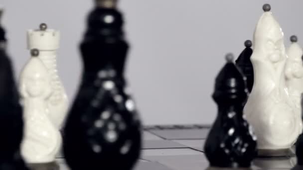 Black and white chessmen on board — Stock Video