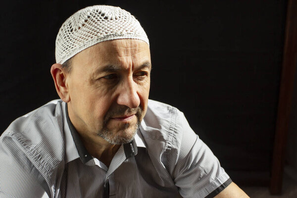 Portrait of Middle Aged muslim man in a mosque and sunlight falling from the window
