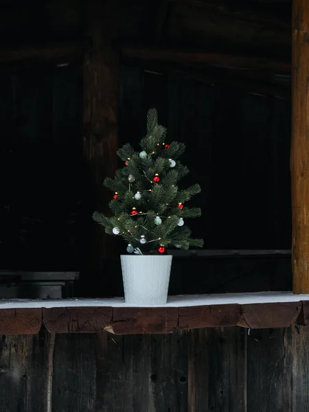 Christmas tree at wooden building — Stock Photo, Image