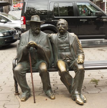 SOFIA, BULGARIA - OCTOBER 09, 2017: monument to father and son Slaveykov on Slaveykov square, classical Bolgarian poets, build in beginning of 21 century. clipart