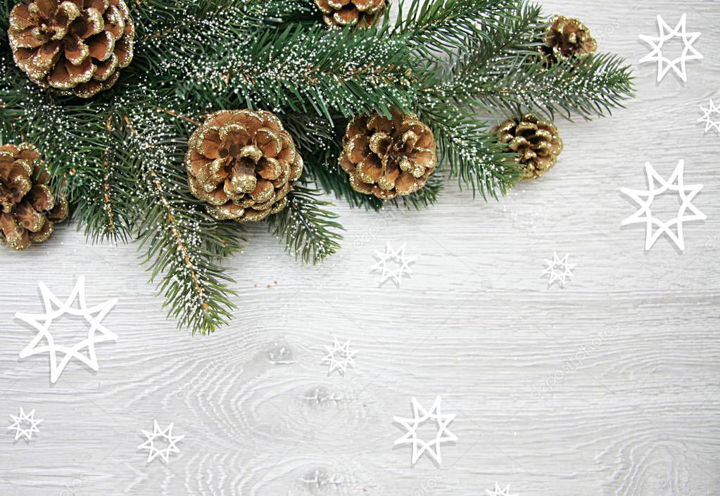 Christmas and New Years composition. The pine cones, spruce branches on a wooden white background
