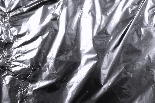 Skrynkliga silver aluminiumfolie bakgrund, abstrakt textur — Stockfoto