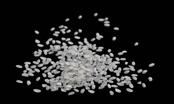 White rice pile isolated on a black background — Stock Photo, Image