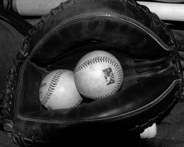 Baseball glove and Baseball sitting on the bench in the dugout before a game. clipart