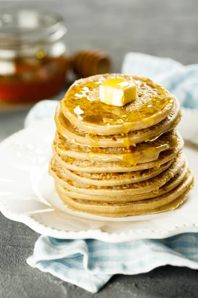 Homemade buckwheat pancakes with honey and butter