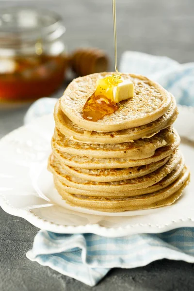 Homemade buckwheat pancakes with honey and butter
