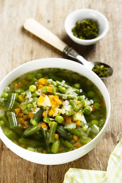 Homemade soup with green bean, carrot and pea