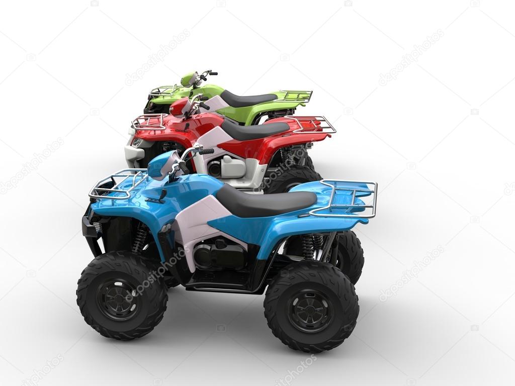 Red, green and blue four wheelers - side view
