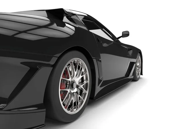 Pitch black modern sports car - rear wheel closeup shot — Stock Photo, Image