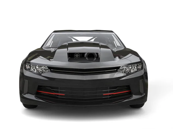 Jet black modern muscle car - front view close seup shot — стоковое фото