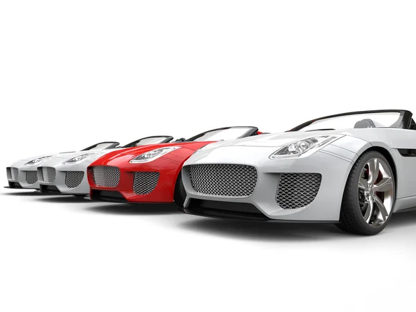 Red sports car stands out amongs white sports cars — Stock Photo, Image