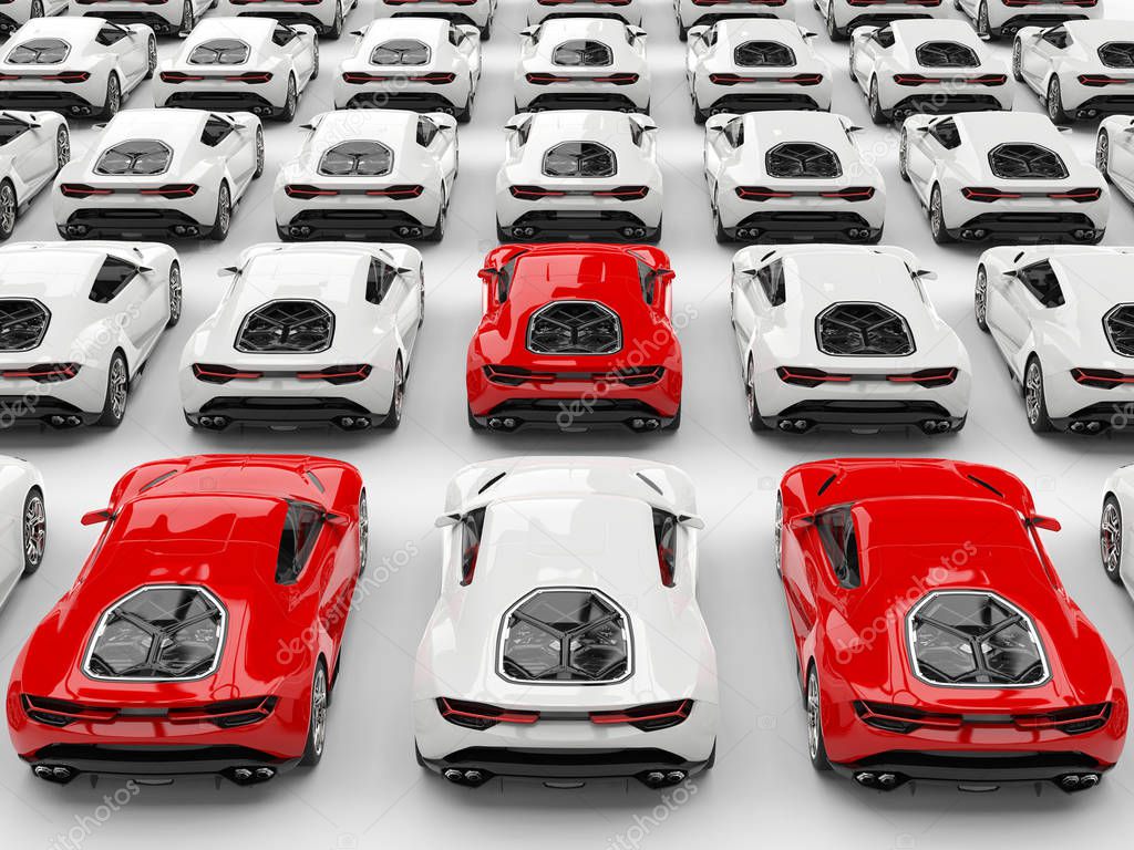 Three red sports cars stand out amongs many white cars