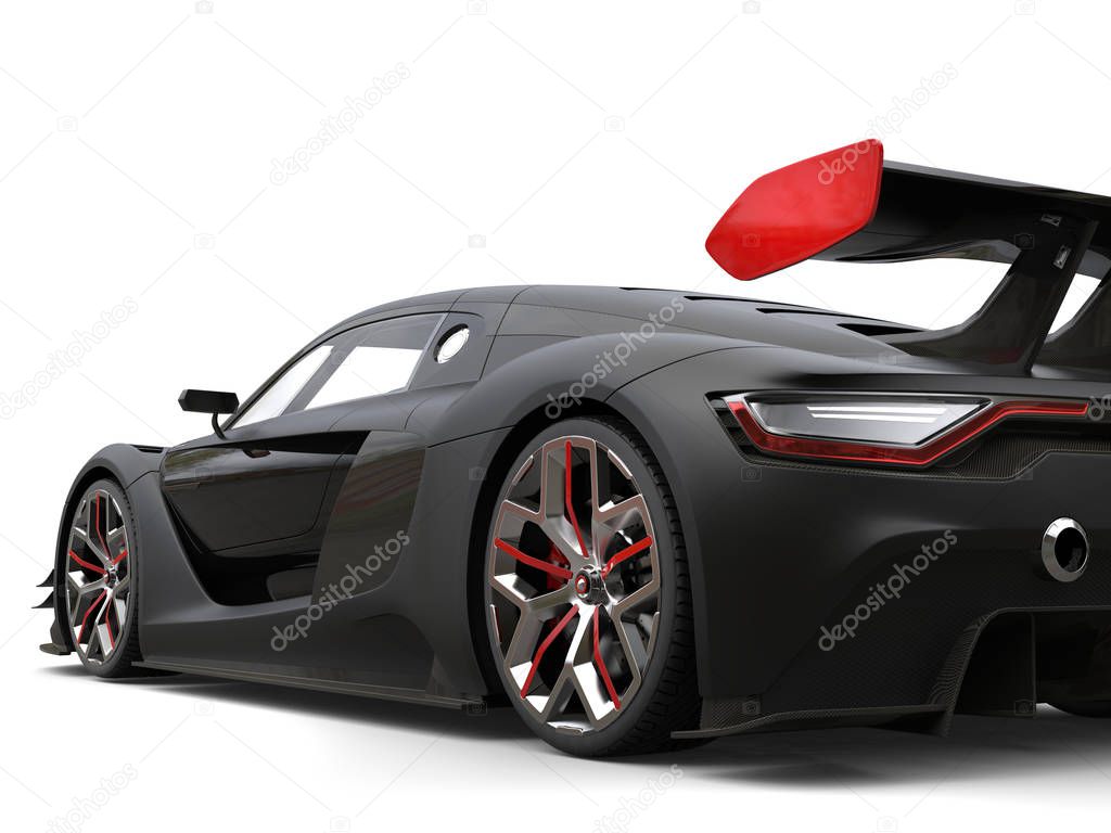 Gorgeous matte black super car with red details on the wheels and rear wing