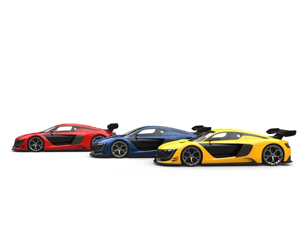 Red, blue and yellow supercars - red one in the front - side view — Stock Photo, Image