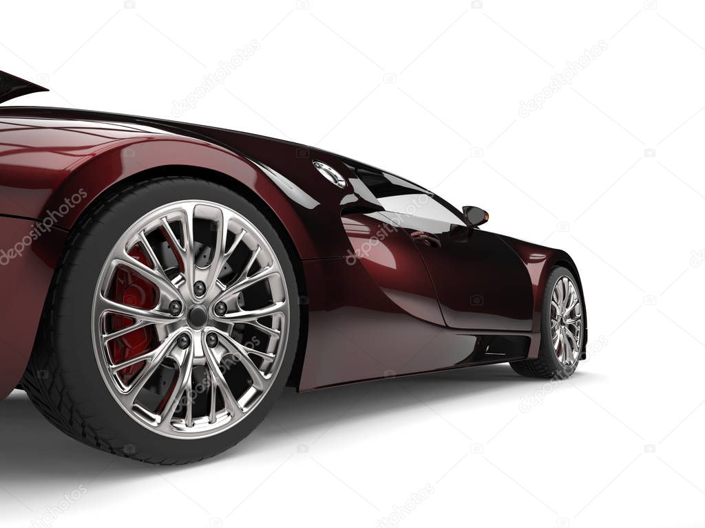 Metallic dark red modern super sports car - rear wheel closeup shot