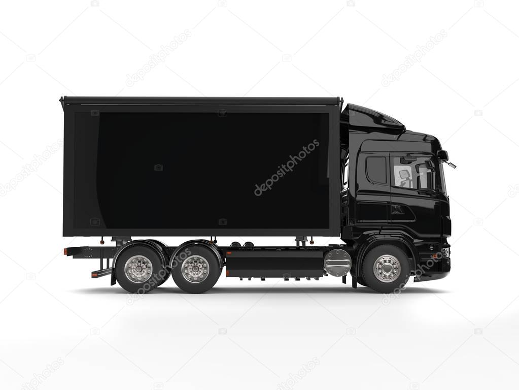 Modern black heavy transport trucks with black trailer