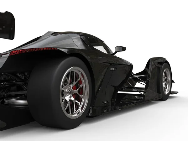 モダンな光沢のある黒スーパー スポーツ レースカー 後輪クローズ アップ ショット — ストック写真