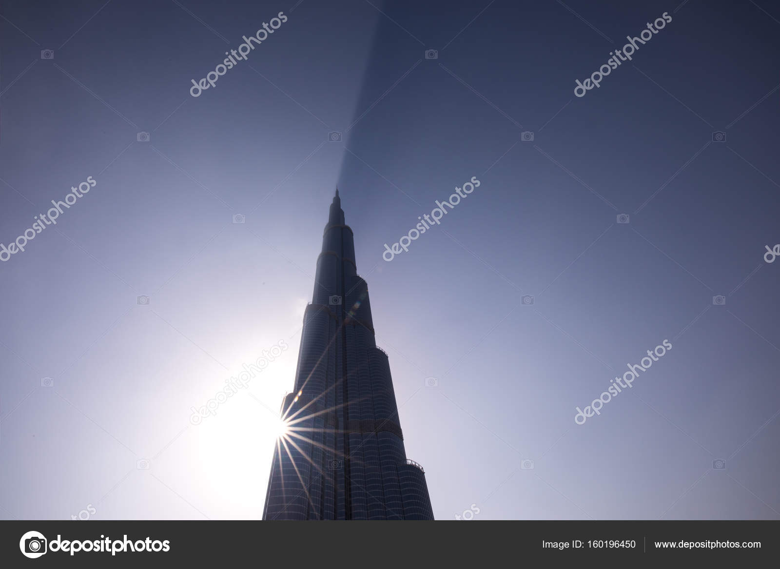 Burj Khalifa casting a shadow through clouds during a sunrise. – Stock ...