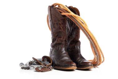 Western boots and a lap or lariat rope and spurs on a white background