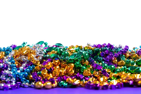 Mardi Gras beads on white background — Stockfoto
