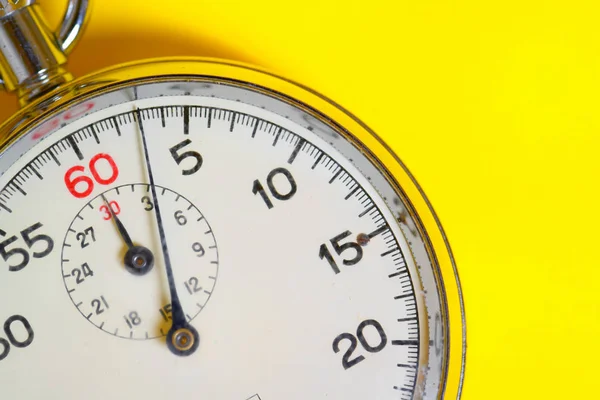 Classic stopwatch on a yellow background — ストック写真