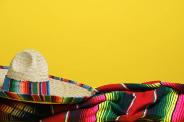 Sarı arka planda renkli bir battaniye üzerinde Meksika sombrero 'su. Cinco de Mayo teması