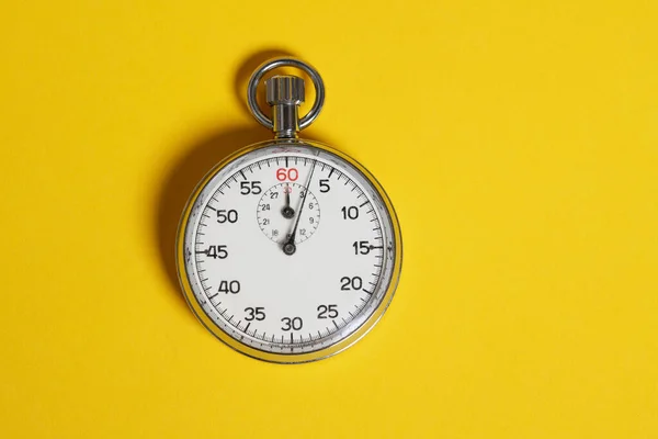 Classic stopwatch on a yellow background — ストック写真