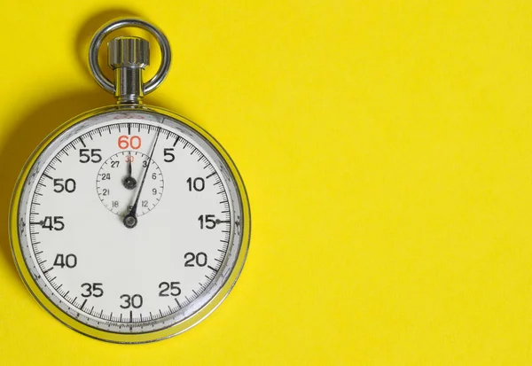 Classic stopwatch on a yellow background — Zdjęcie stockowe