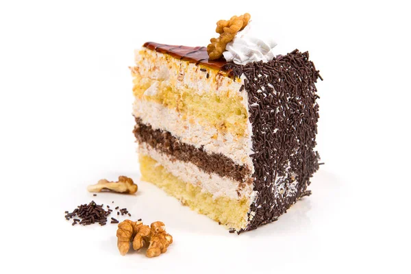 Piece of cake. Layers of biscuit with caramel butter cream, nuts and chocolate. Sweet food and dessert.