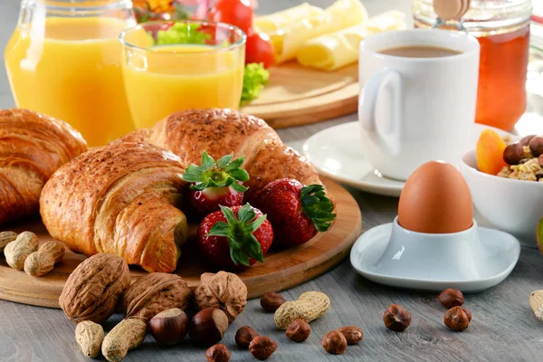 Breakfast consisting of croissants, coffee, fruits, orange juice — Stock Photo, Image