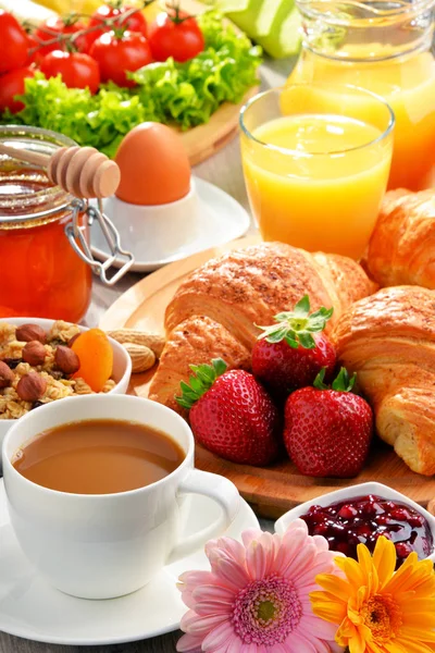 Breakfast consisting of croissants, coffee, fruits, orange juice — Stock Photo, Image