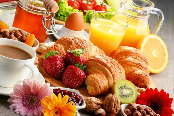 Frühstück bestehend aus Croissants, Kaffee, Obst, Orangensaft — Stockfoto