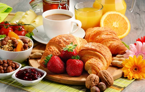 Breakfast consisting of croissants, coffee, fruits, orange juice — Stock Photo, Image