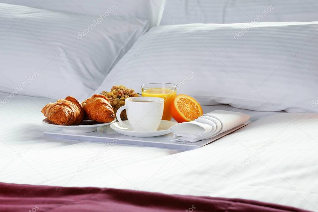 Breakfast in bed in hotel room.